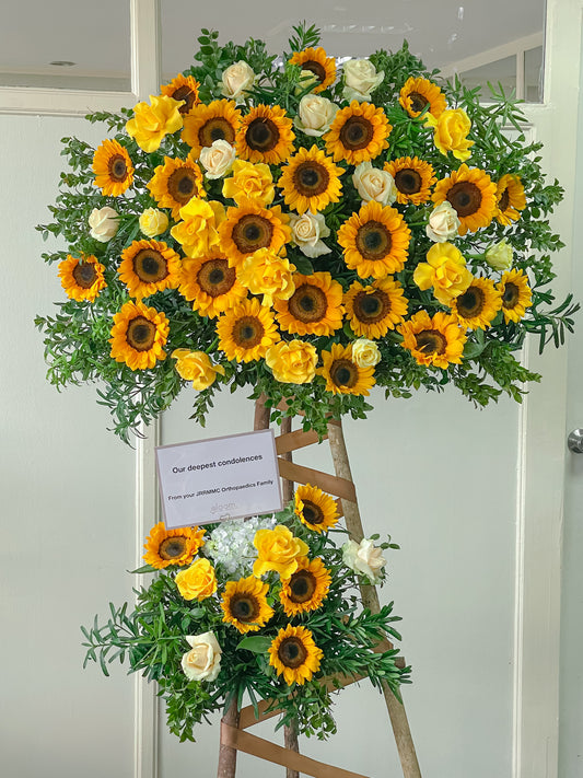 Adora sympathy standee with sunflowers and white roses
